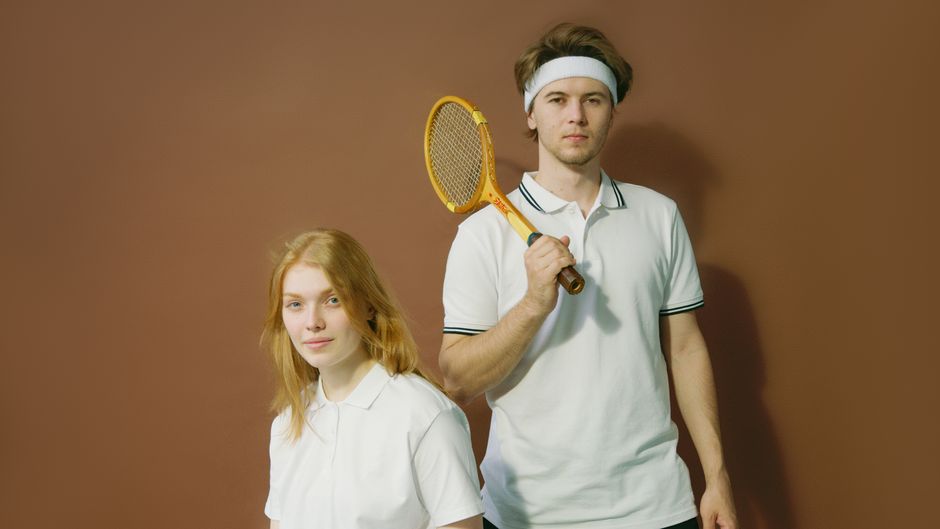 A mixed pair playing padel together