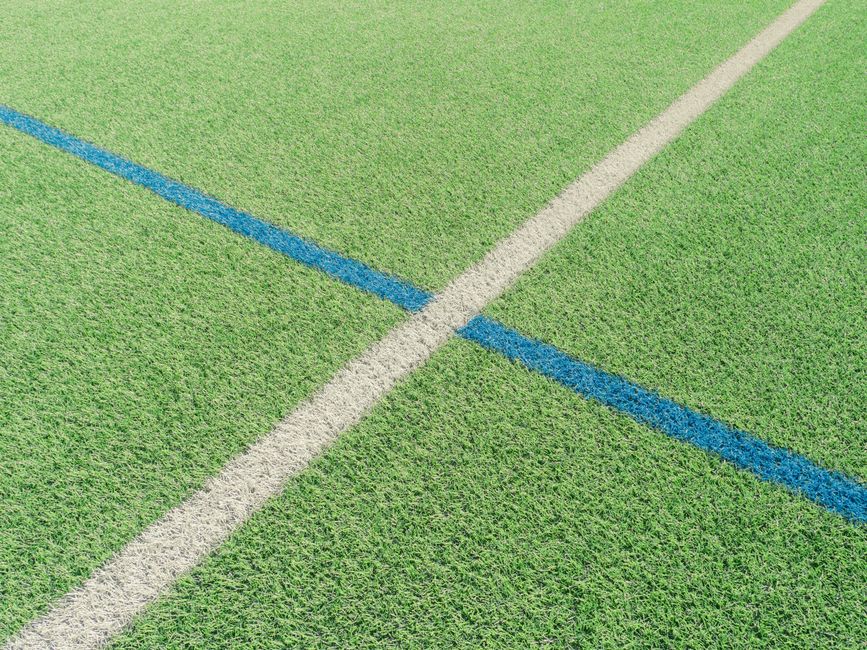 Close-up of artificial turf padel court surface with white lines