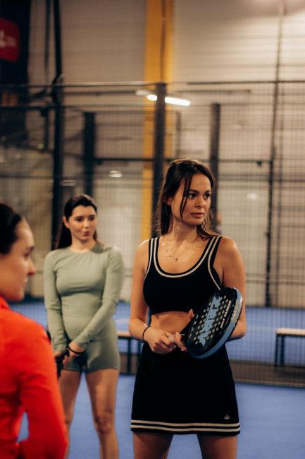 Group playing padel on an indoor court