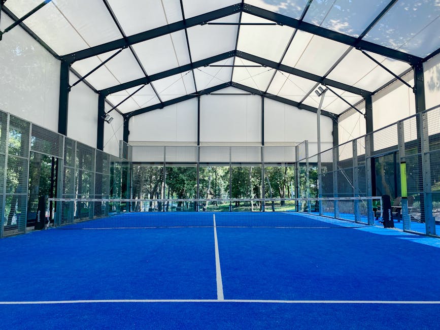 Indoor padel court with glass walls — the enclosed format that distinguishes padel from tennis