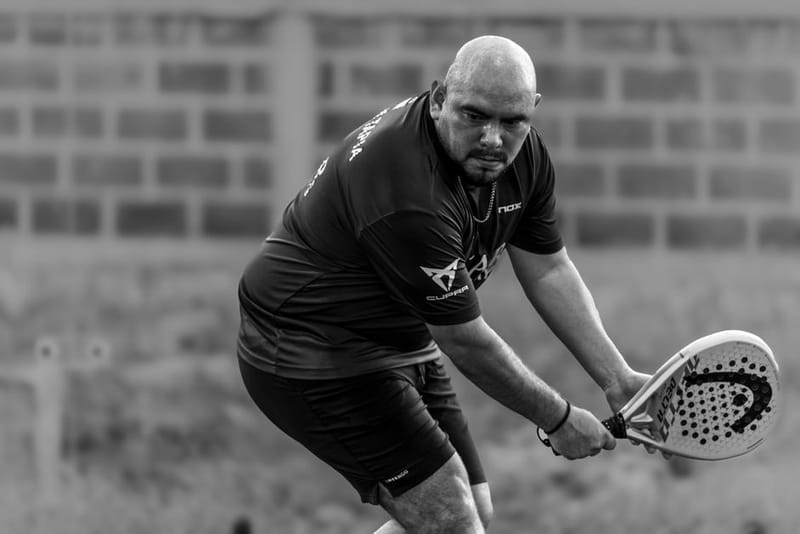 Padel player hitting an overhead smash with a diamond racket