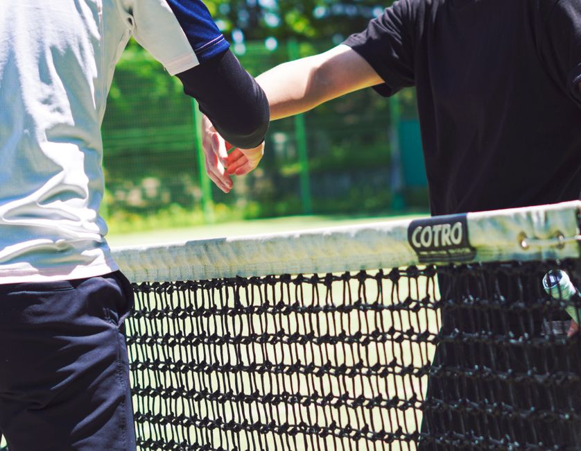 Padel players competing at the net during a match