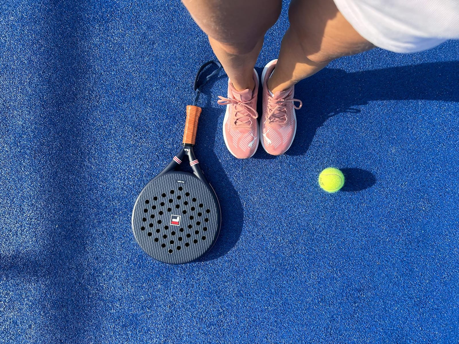 Padel racket on the surface of a padel court